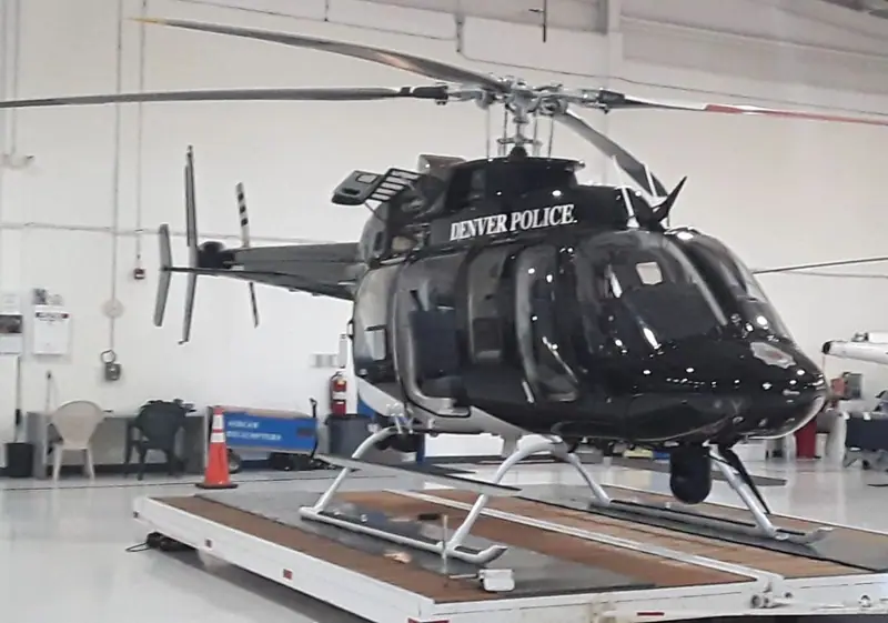 Black and white helicopter with glossy paint parked in a hangar, from Patriot Ceramics photo files